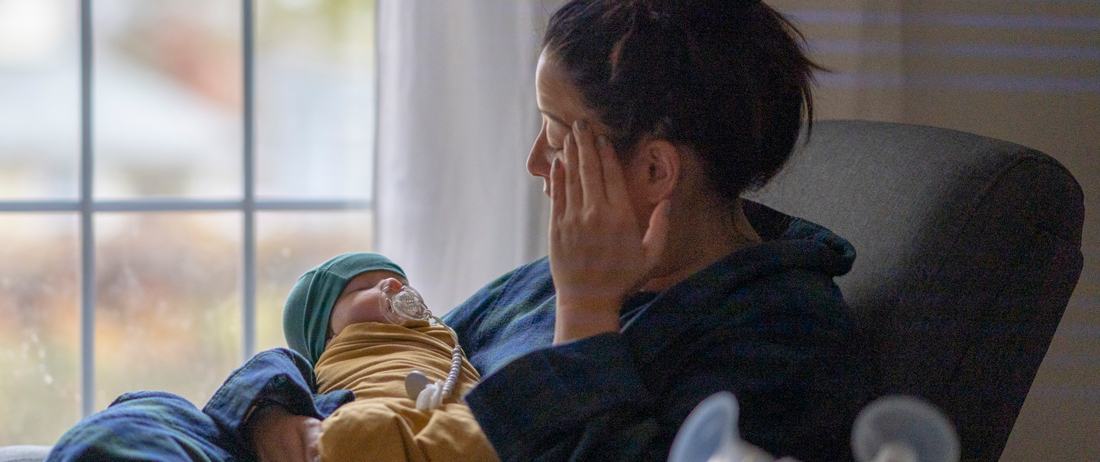 woman with postpartum depression holding baby