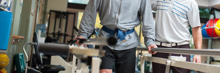 man working with a therapist in physical therapy