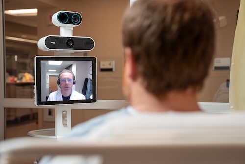 A patient meets with a physician via Teladoc