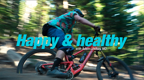 man riding mountain bike through the woods