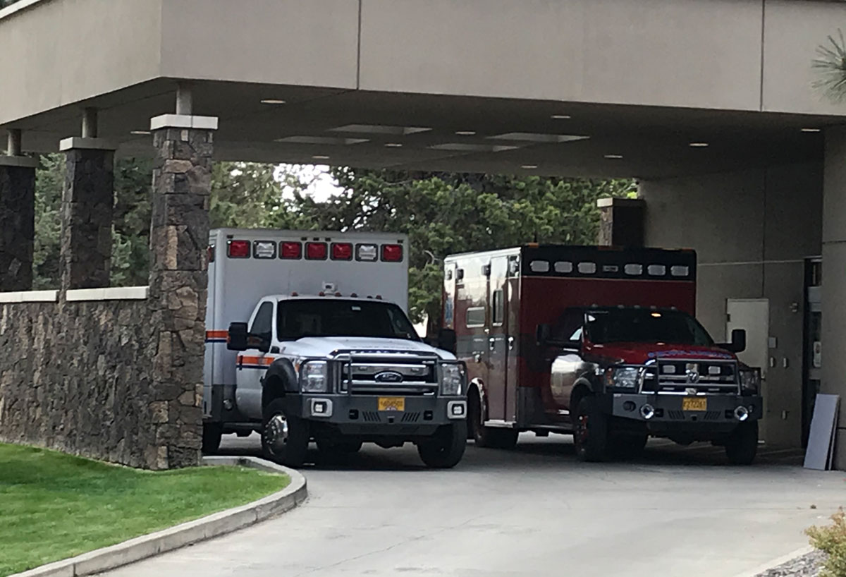 Ambulances sit outside St. Charles Bend Emergency Room