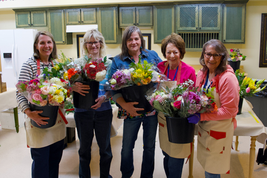 St. Charles Blossom volunteers creating flower bouquets for hospice care patients.