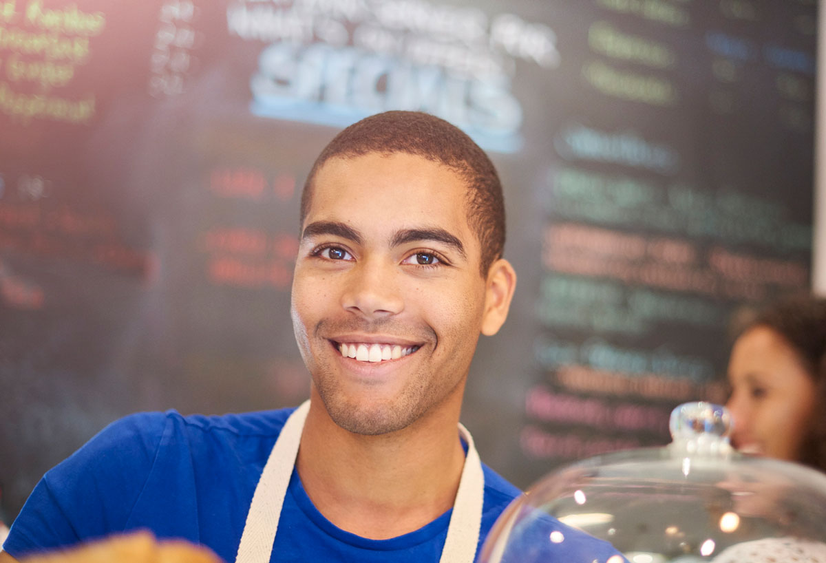 Young man working counter at cafe