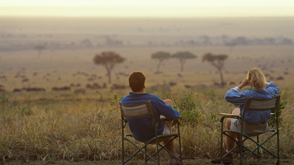 couple looking out at a field in Africa