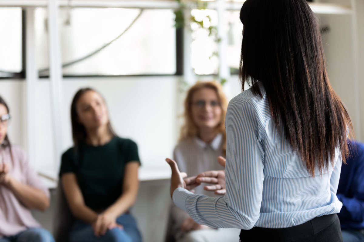 woman talking to a group of others